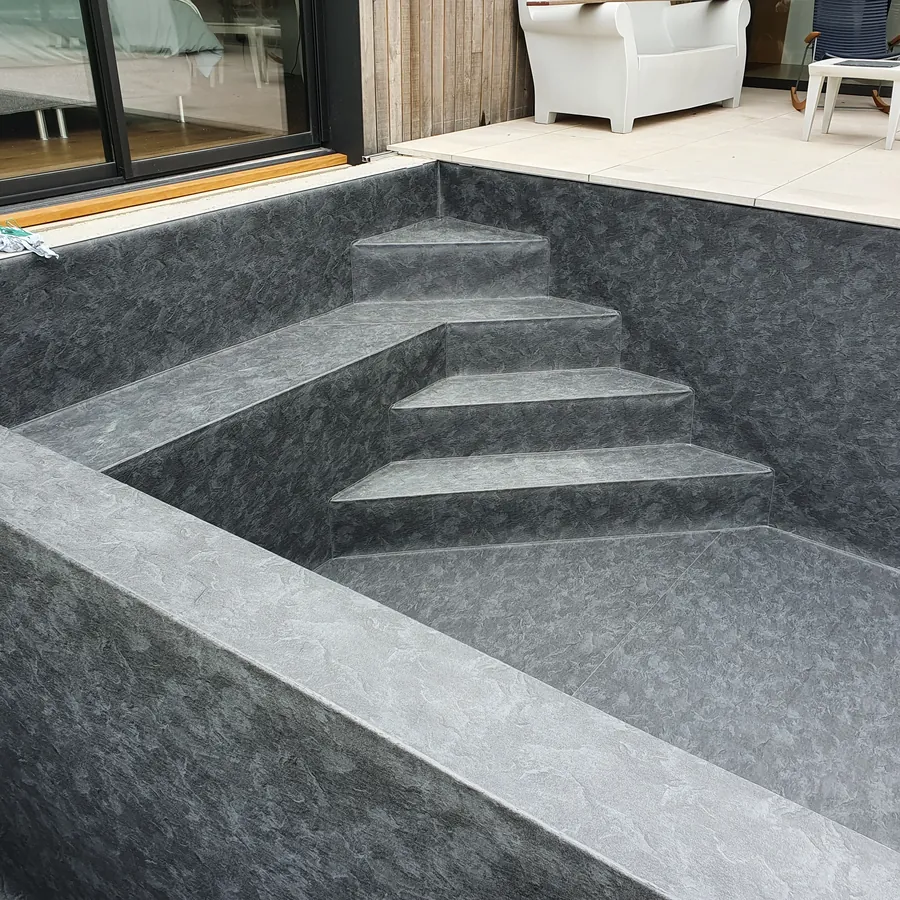 Piscine en PVC armé anthracite bordée d'une terrasse